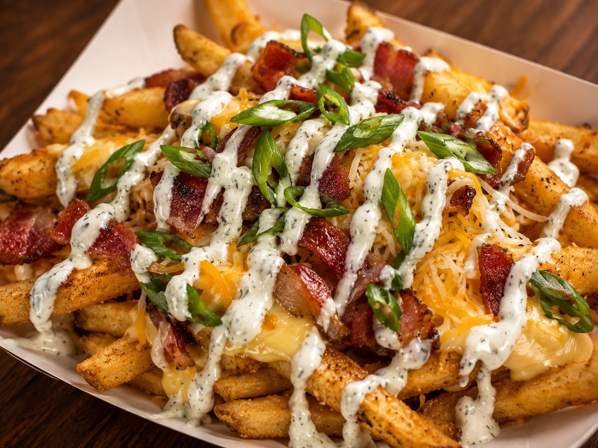 Loaded Fries topped with cheese sauce, shredded cheese, thick-cut bacon, green onion and ranch drizzle at Stage Stop, Colorado Springs