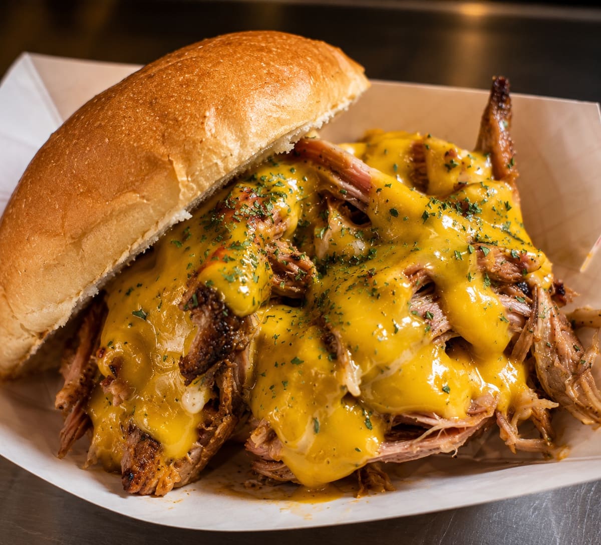 Pulled Chicken Sandwich smothered in cheese sauce on a toasted brioche bun at Stage Stop, Colorado Springs